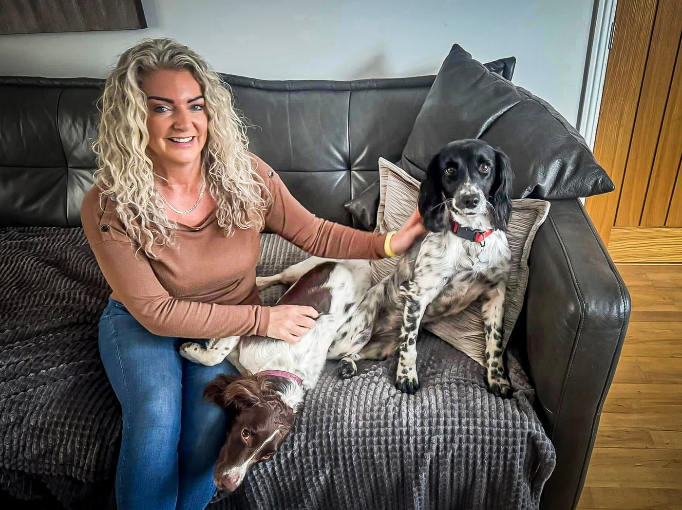 Sue relaxing with one of the dogs at Pawsome